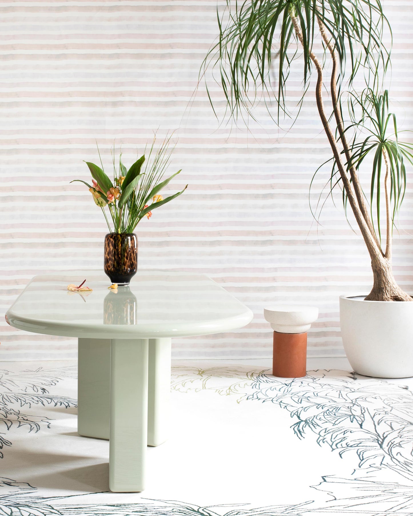 A coffee table with a Gradient Stripe Wallpaper Pink Island AND fabric on top of it