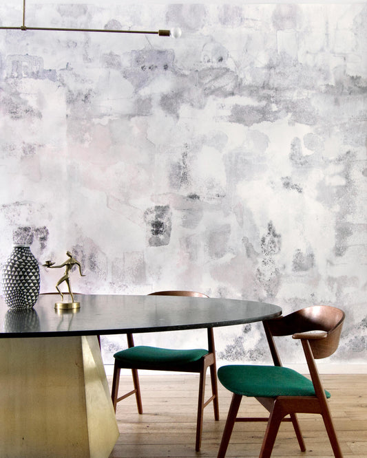 A dining room with a Kotoubia Wallpaper Mural Blanca tablecloth and elegant chairs in front of a wall