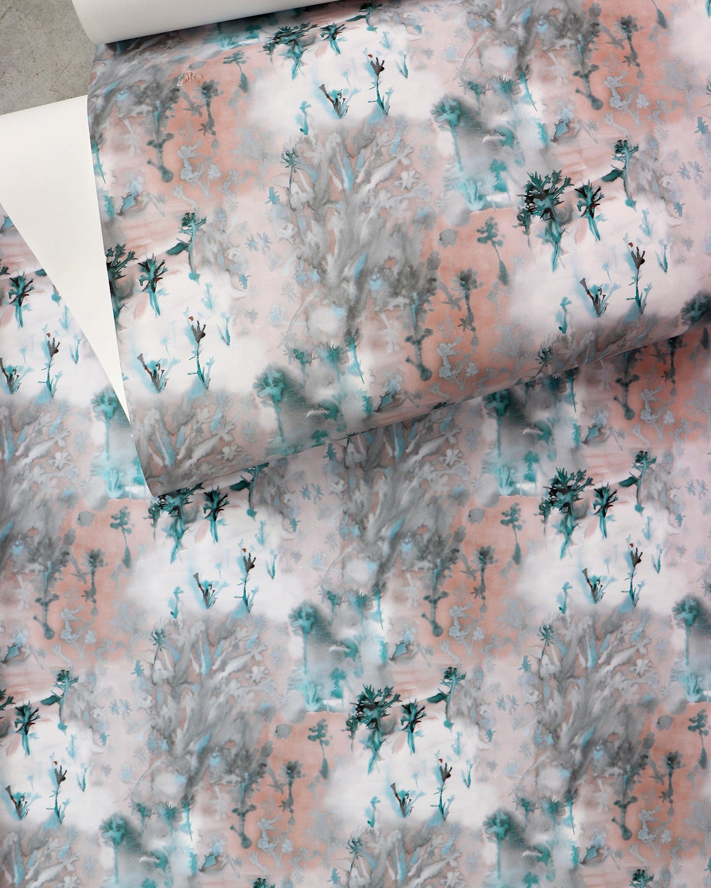 A piece of Emvasia Wallpaper with a pink, blue, and green pattern