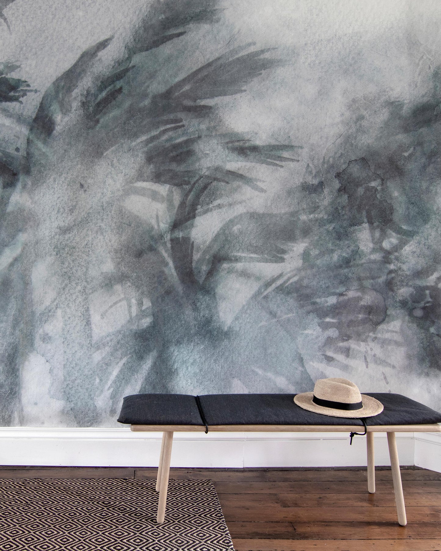 A bench in front of a wall with a Reflettere Wallpaper Mural Notte