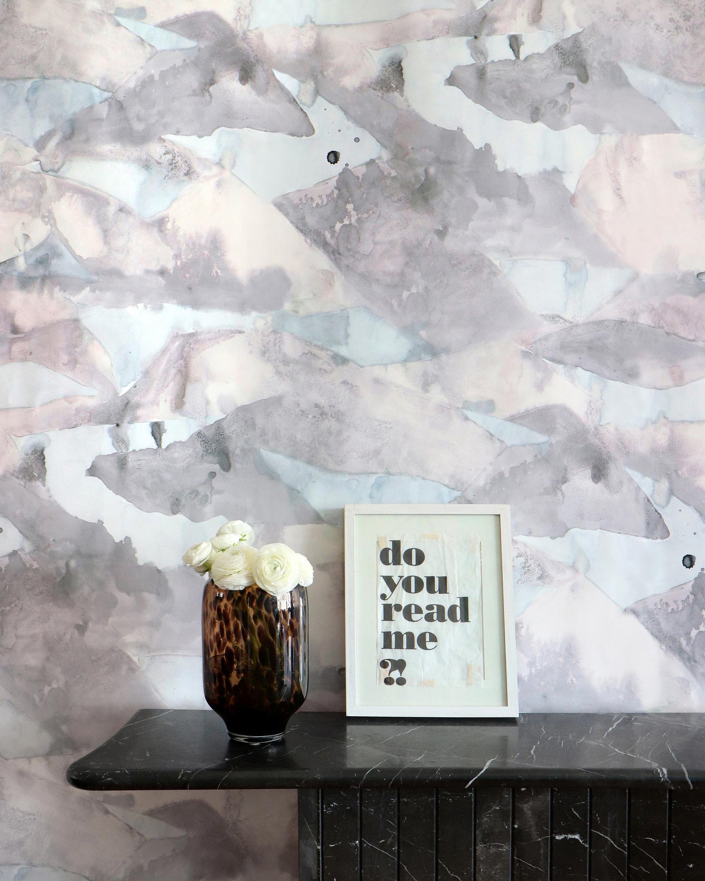 A vase of flowers on a table next to a Mani Wallpaper Dusk