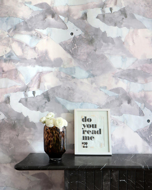 A vase of flowers on a table next to a Mani Wallpaper Dusk