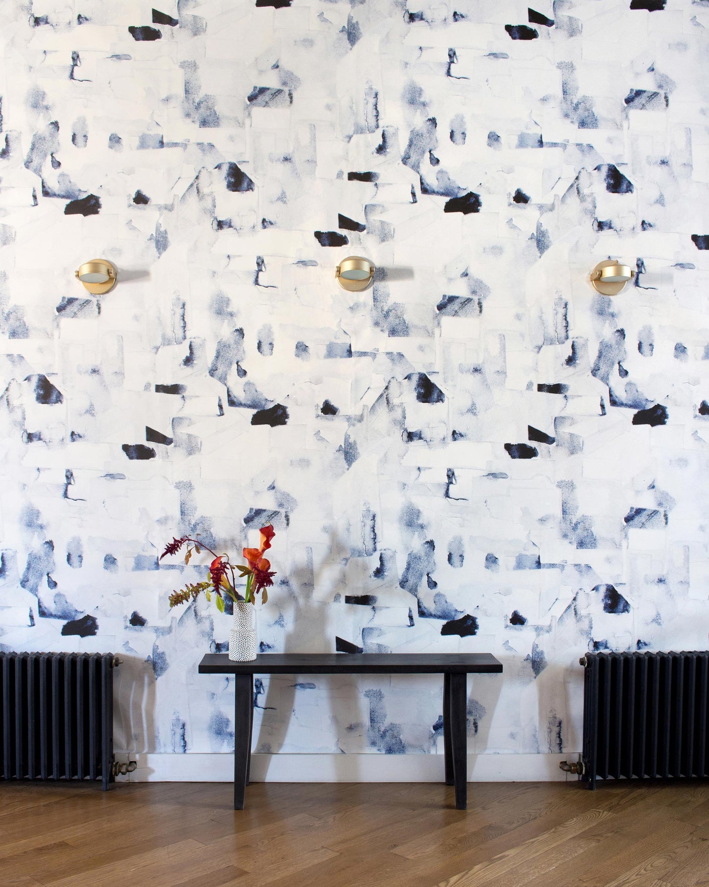 A room with black and white Medina Wallpaper Cyrrus roofs and a bench
