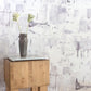 A Cherifia Wallpaper Blanca with a vase in front of it
