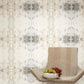 A chair with a bowl of grapes in front of a Roman Ram Wallpaper Light Metal