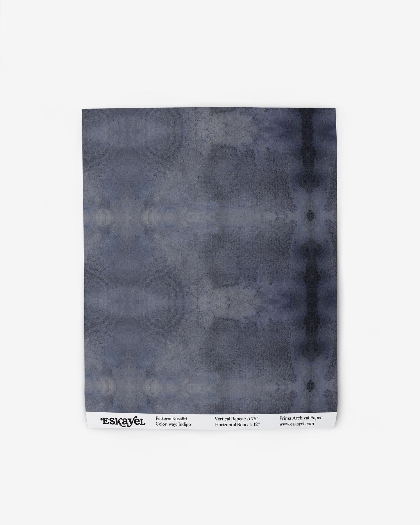 A blue tie dye pattern on a Kusafiri Wallpaper Indigo fabric