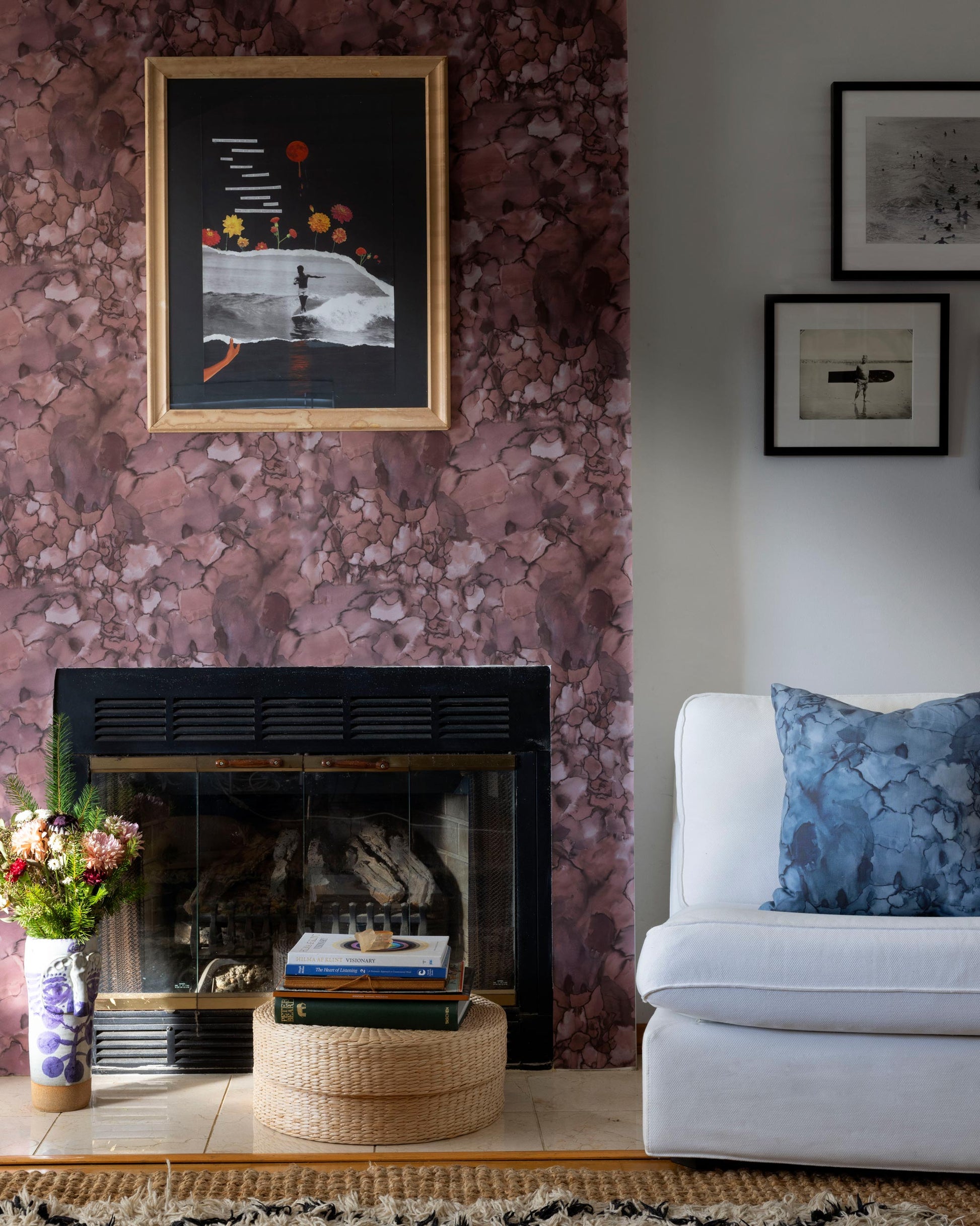 A living room with a high-end fireplace and Earth colorway floral walls, featuring Kassia x Eskayel Aquarelle Wallpaper Earth