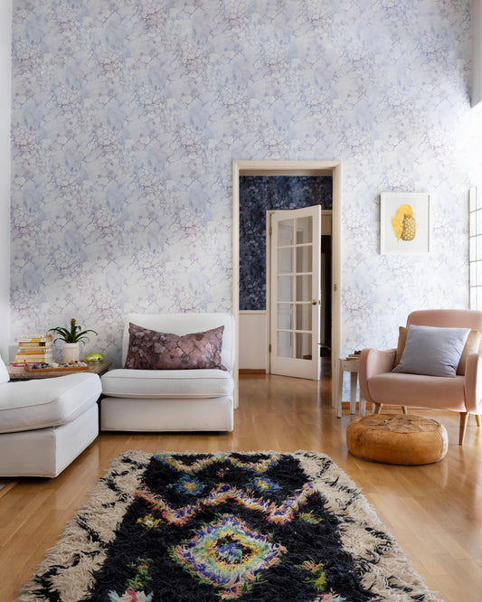 A living room with high-end, custom Aquarelle Wallpaper Ice, creating a luxurious ambiance, and a rug