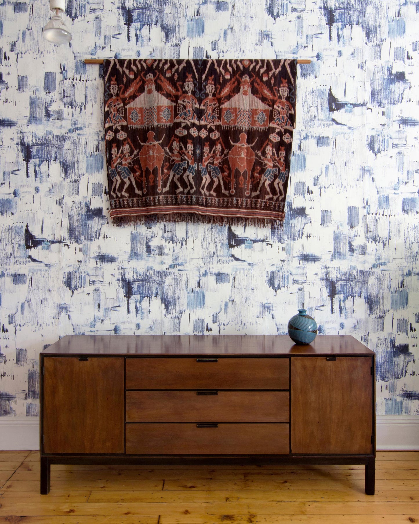 A luxurious, high-end Cherifia Wallpaper adorns the room, complementing the wooden dresser