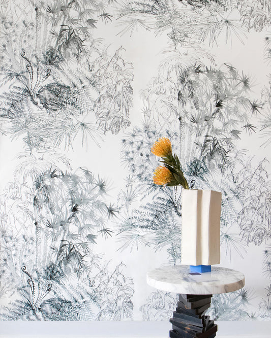 A vase on a table showcasing the Domenica Wallpaper Notte pattern from the Salentu Collection in front of a luxurious fabric