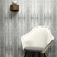A white chair in front of a gray Feudal Facet Wallpaper Slate