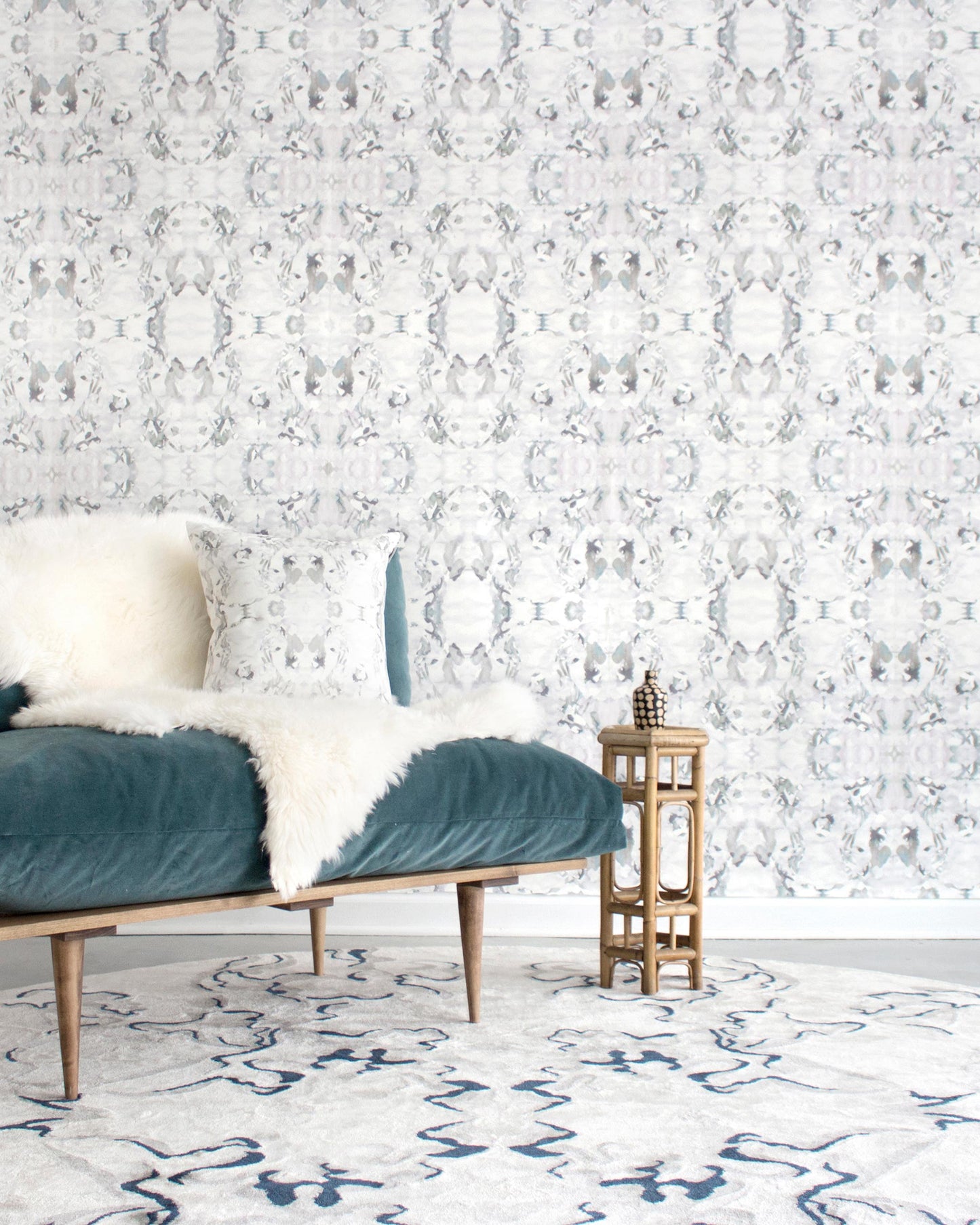 A living room with a Huerfano Wallpaper Ash couch in an Ash colorway