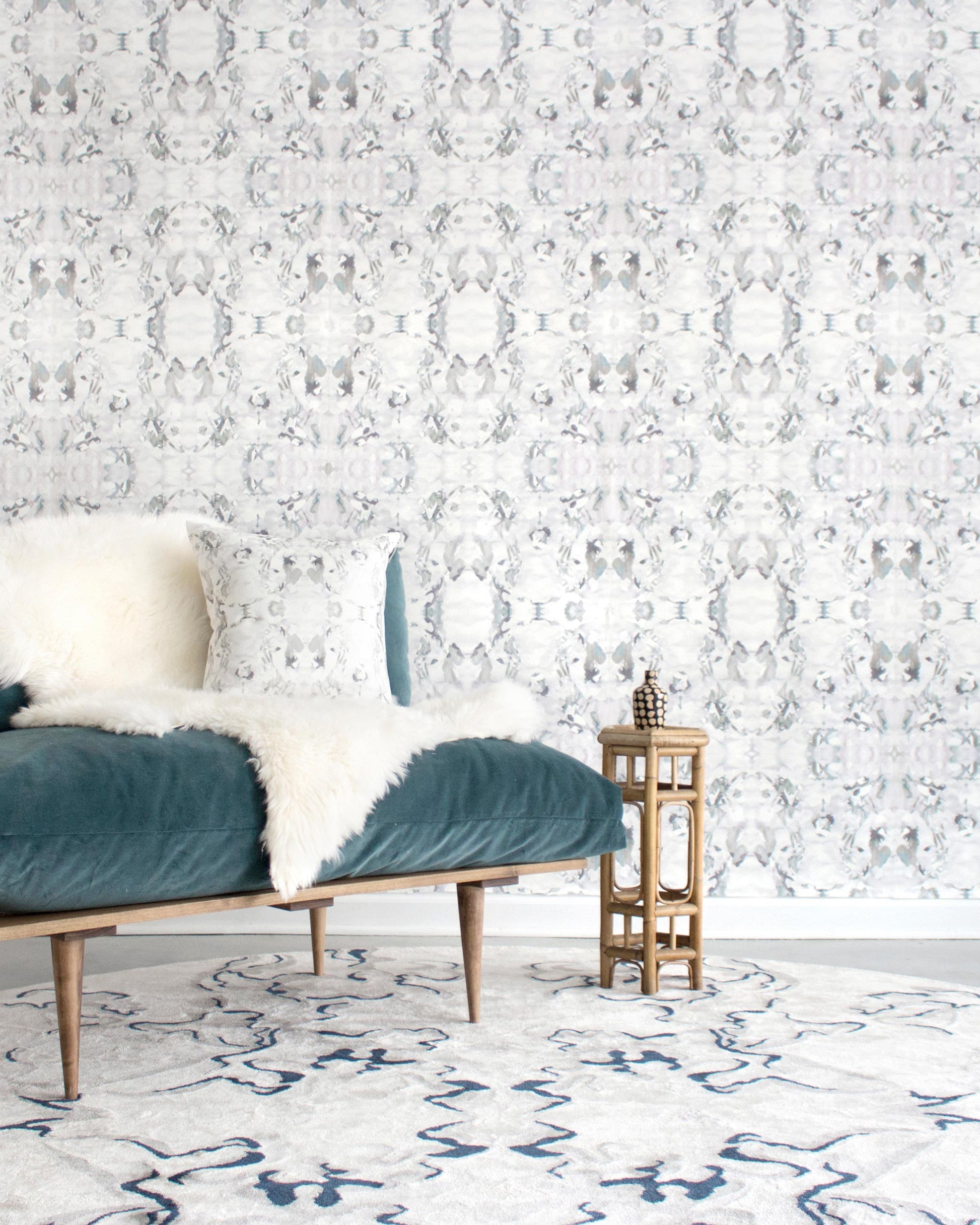 A living room with a Huerfano Wallpaper Ash couch in an Ash colorway