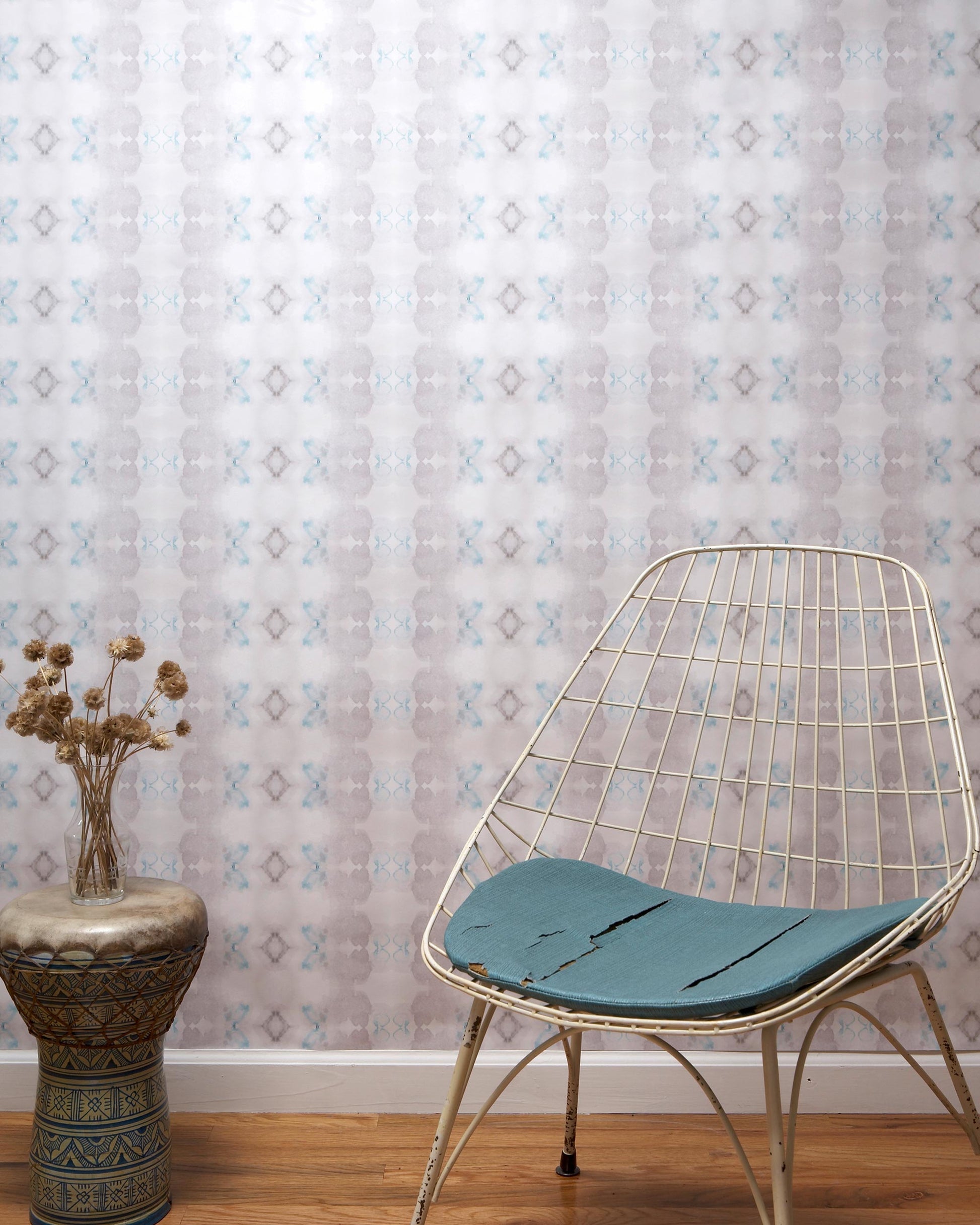 A luxurious Icelandic Mist Wallpaper sits in front of a Sea Green chair
