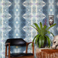 A blue and white Jangala Wallpaper Waterstone in front of a wooden chair