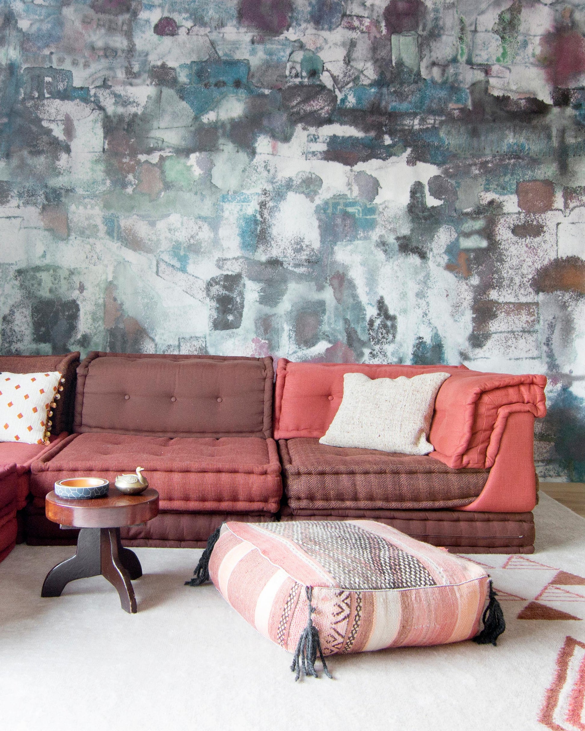A living room with a colorful mural on the Kotoubia Wallpaper Mural Tesoro wall in Morocco