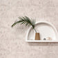 A shelf with a plant and La Scala Wallpaper Shell on it on a white wall