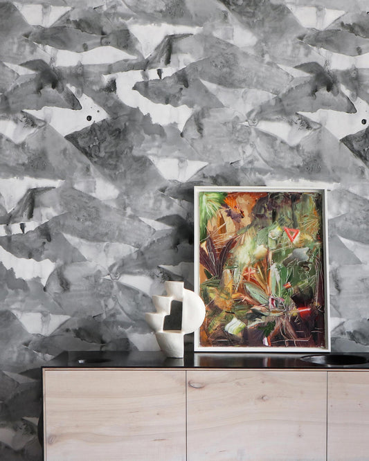 A black and white Mani Wallpaper with a painting in front of it