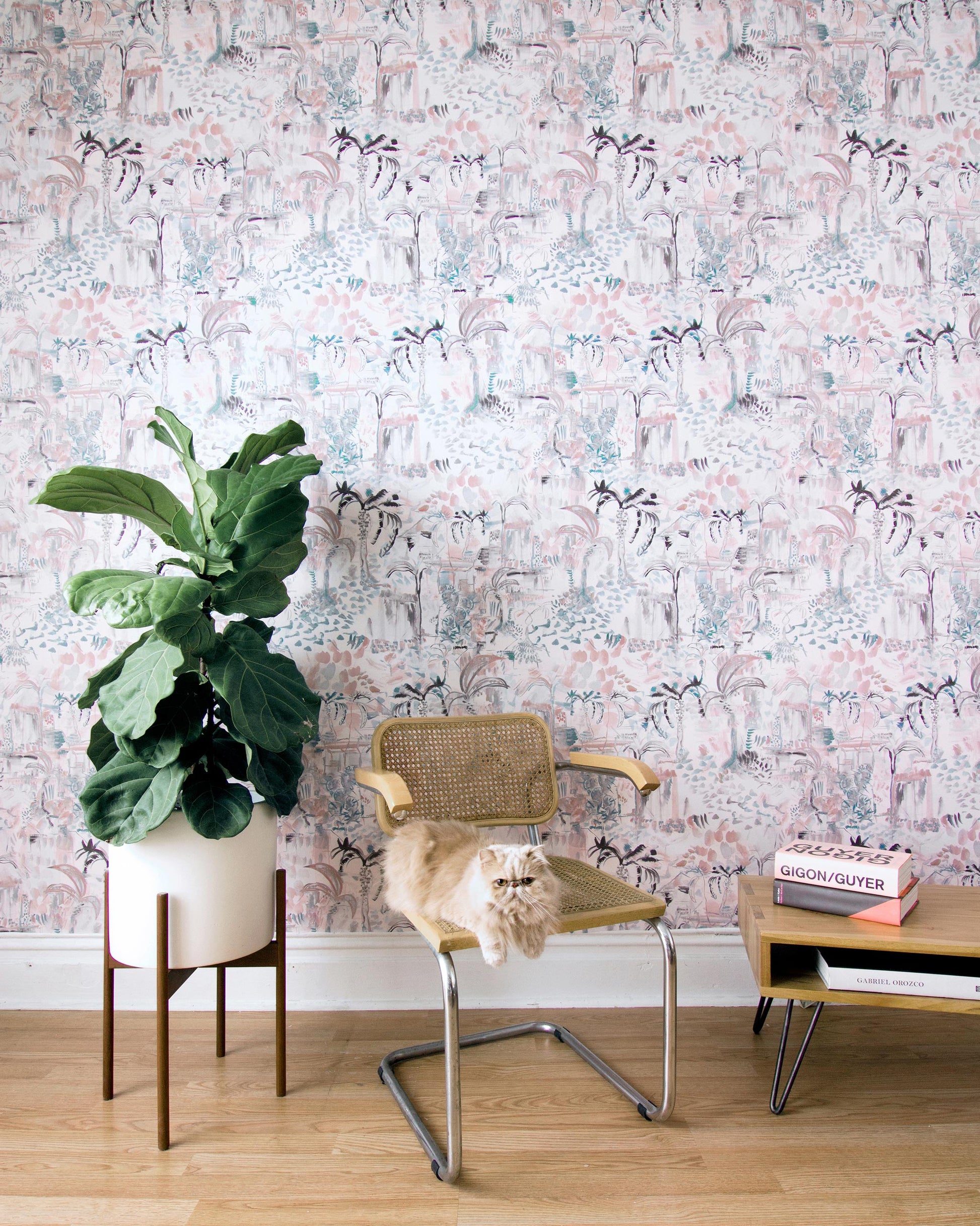 A room with a pink Duomo wallpaper and a chair in front of it