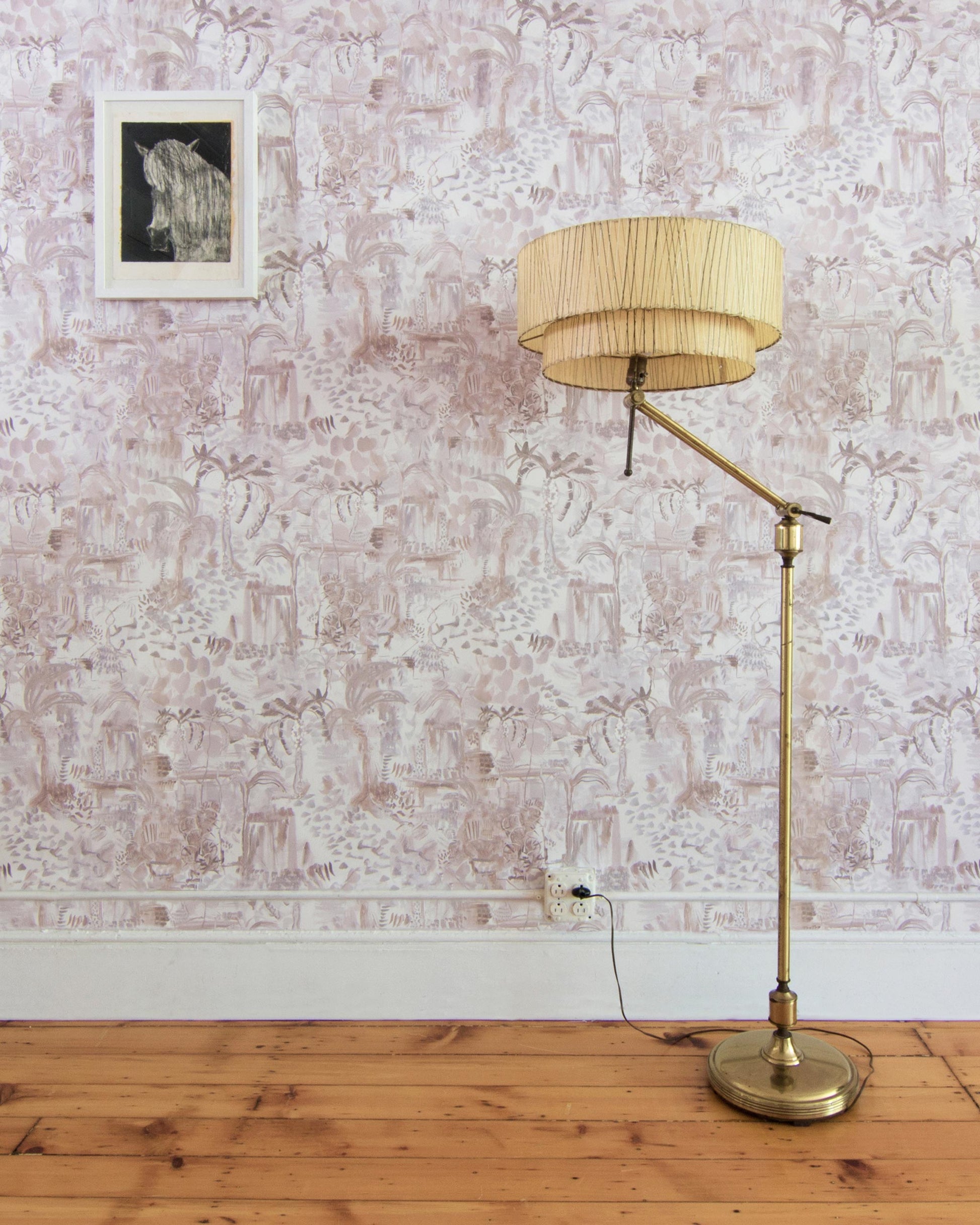 A floor lamp in a room with Souk Wallpaper Pausa