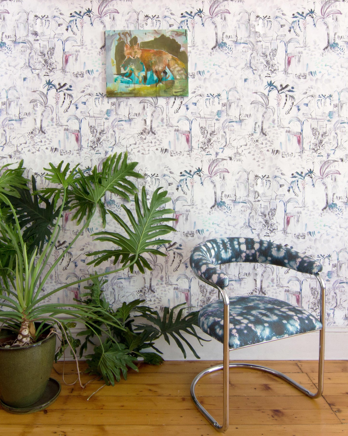 A chair with a plant in front of a Souk Wallpaper Tesoro wall