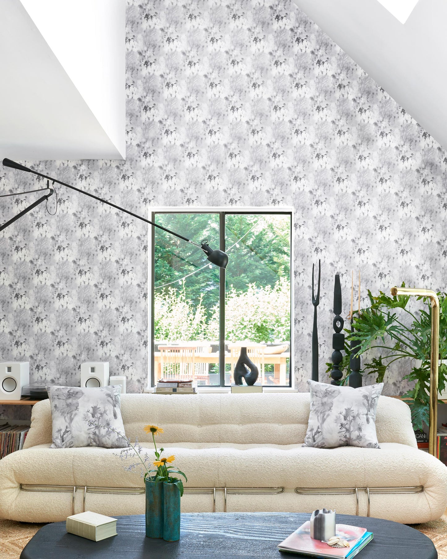 A living room with a white Emvasia Wallpaper Phyllite couch and fabric