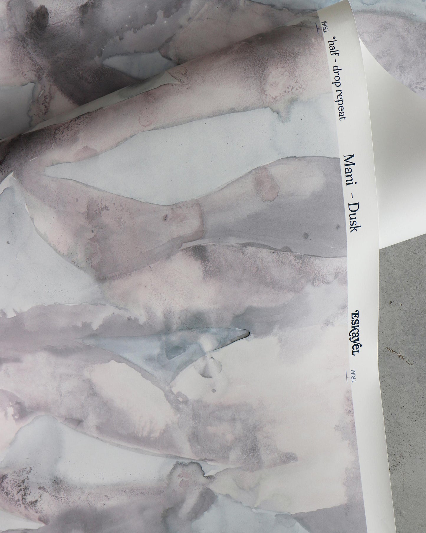A piece of Mani Wallpaper Dusk with a watercolor pattern
