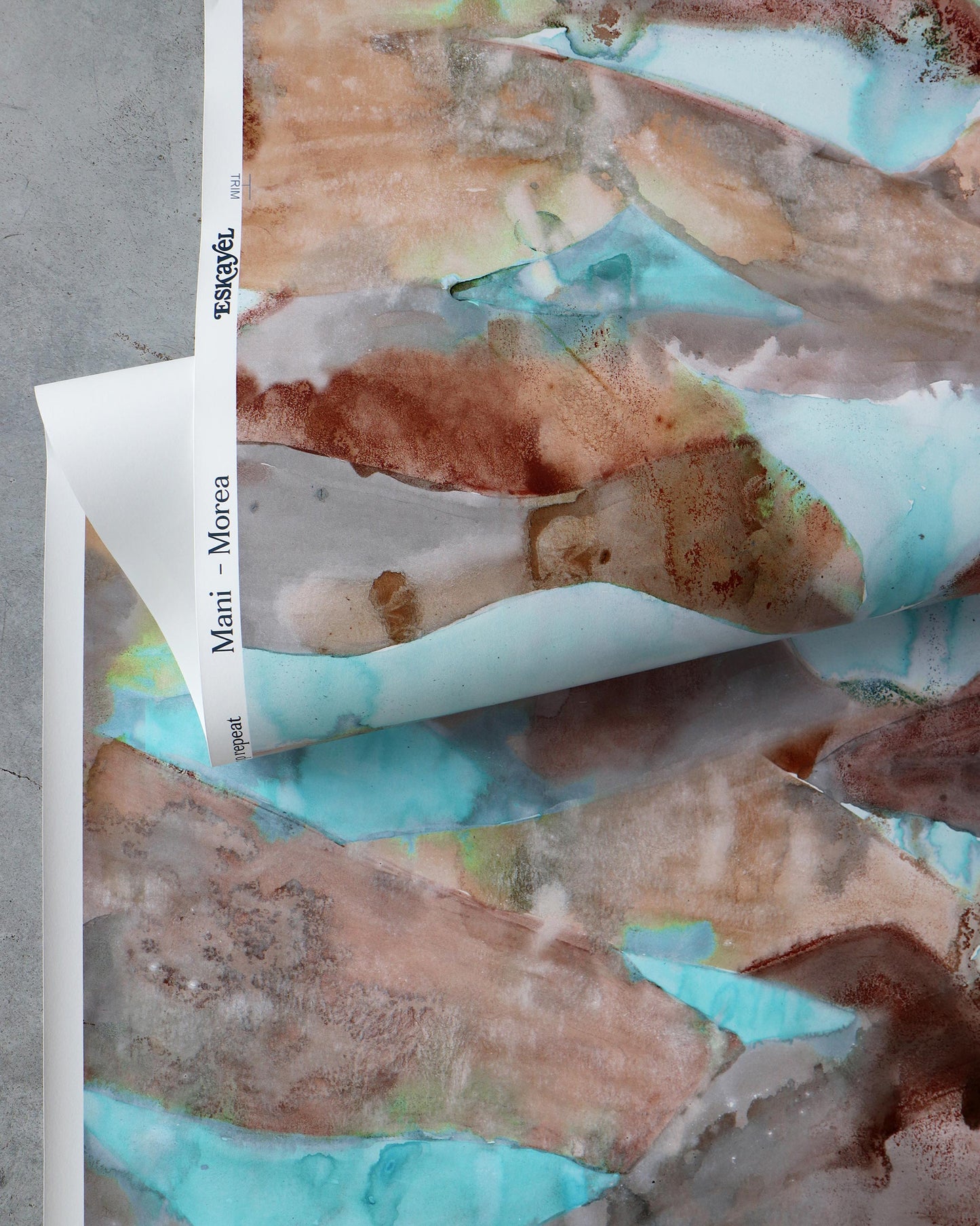 A blue and brown Mani Wallwallpaper Morea on a piece of wallpaper showcasing Greek colorways in Mani