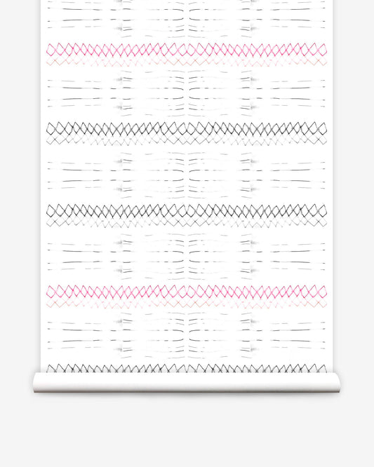 A roll of Native Stripe Wallpaper Black + Crimson with a white and pink graphic pattern