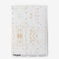 A white Omaha Kinship Wallpaper Flax with gold splatters on it