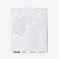 A white piece of Pecosa Wallpaper with a sun motif design on it