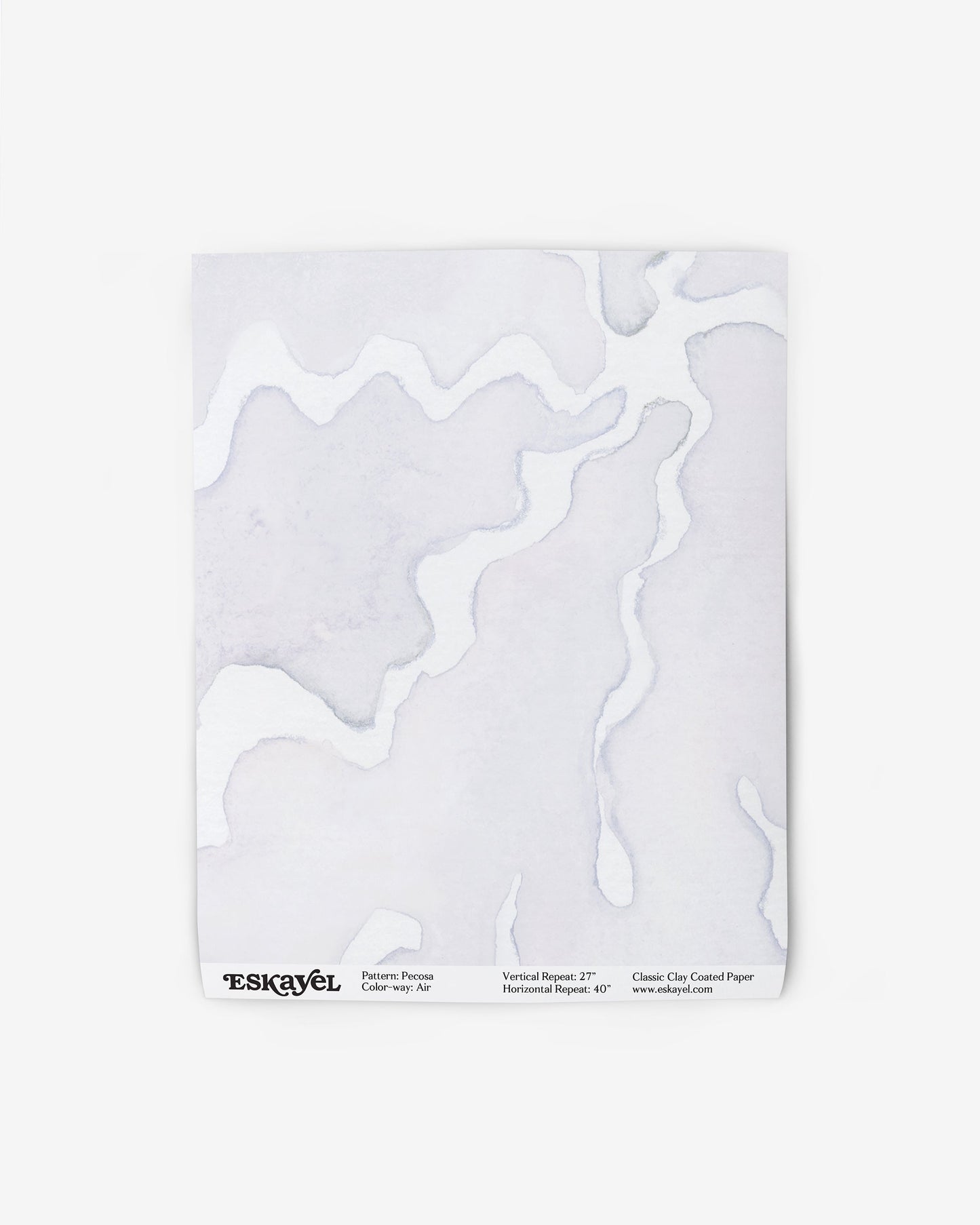 A white piece of Pecosa Wallpaper with a sun motif design on it