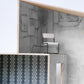 A model of a house with a bed and a chair in Portico Wallpaper Mural Greyscale colorway