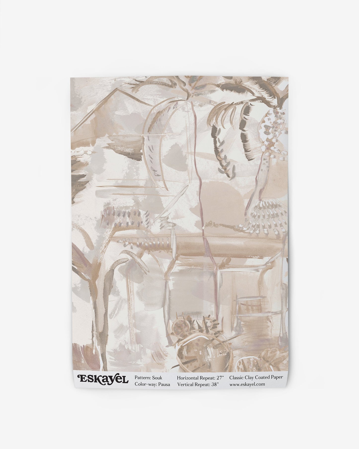 A blanket with a beige Souk Wallpaper||Pausa design on it.