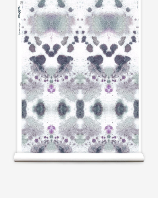 A roll of Species Wallpaper Indigo with a kaleidoscopic effect inked paper in purple and white pattern