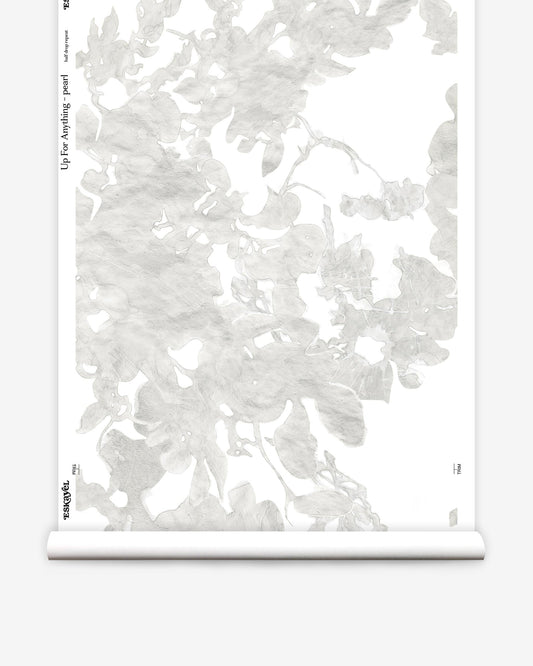 A roll of Up For Anything Wallpaper Pearl with a botanical pattern of white flowers on it