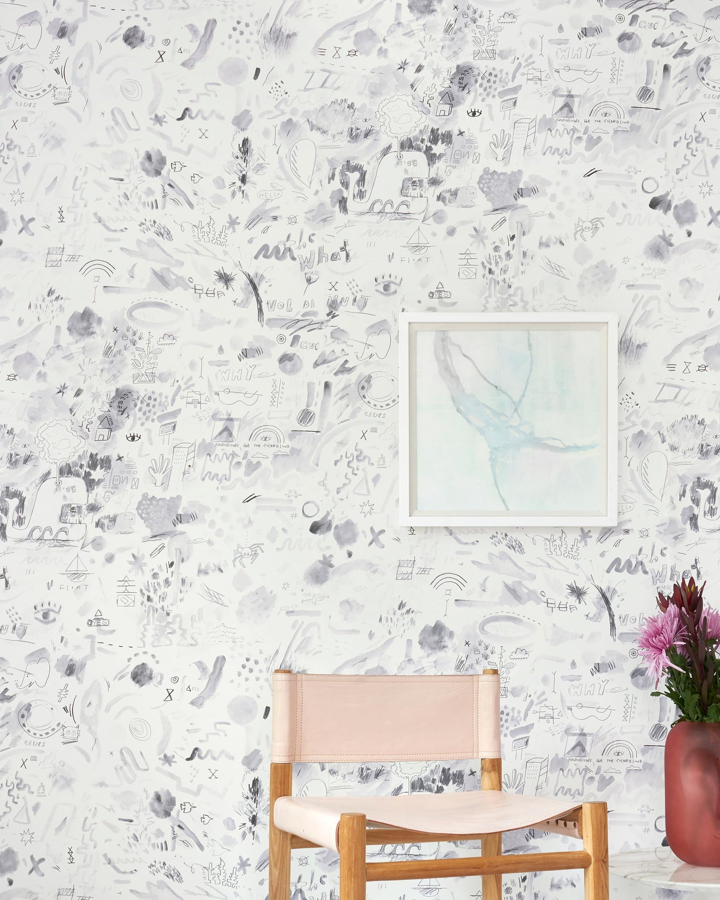 A chair with a pink Vol de Nuit Wallpaper Noire in front of a luxury fabric