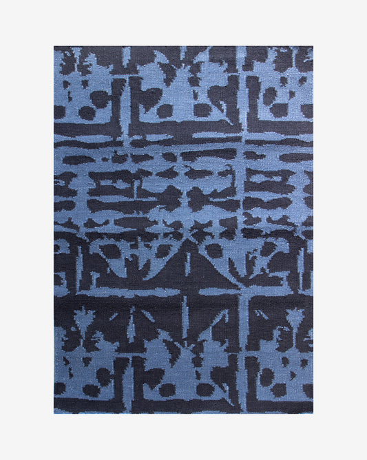 A Banda Flatweave Rug Indigo with an abstract design by Eskayel