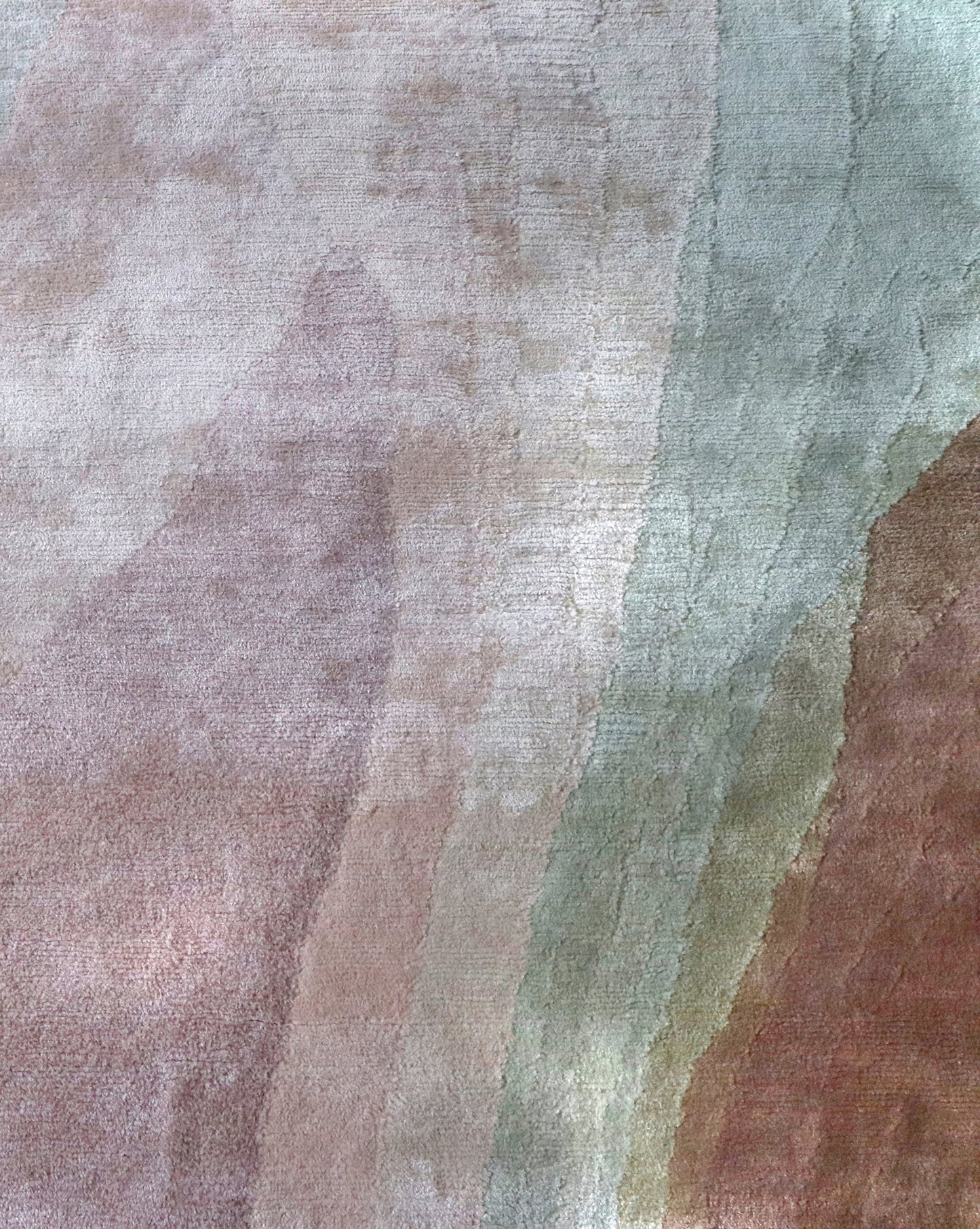 A close up of a pink, green, and brown fabric from the Progressions Hand Knotted Rug in the Corinth colorway