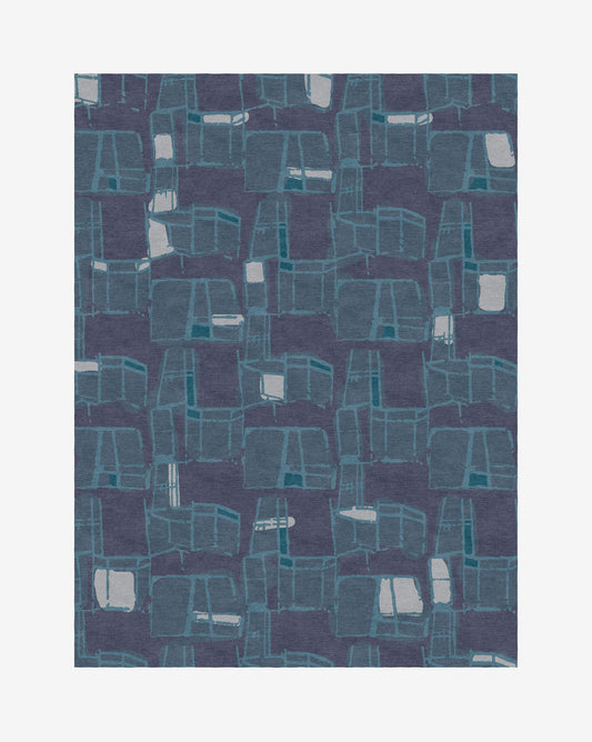 A Quotidiana Hand Knotted Rug with an abstract pattern on a dark blue background