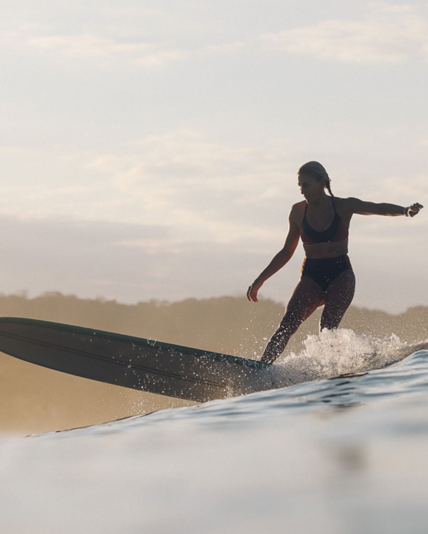 A woman surfing on a wave