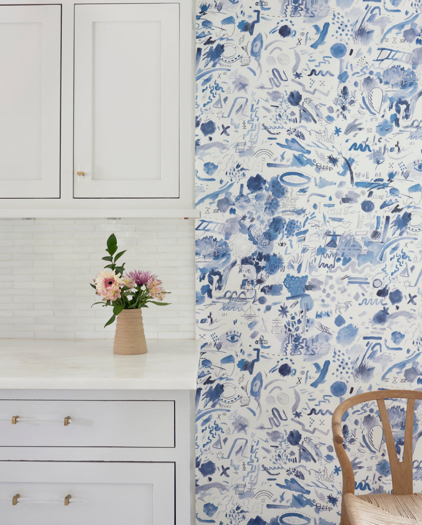 A blue and white wallpaper in a kitchen