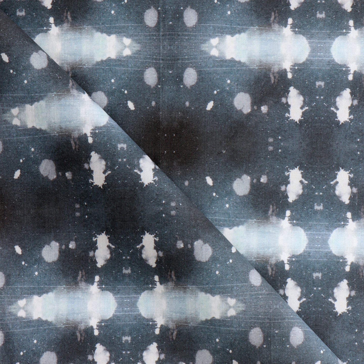 A blue and white fabric with spots on it
