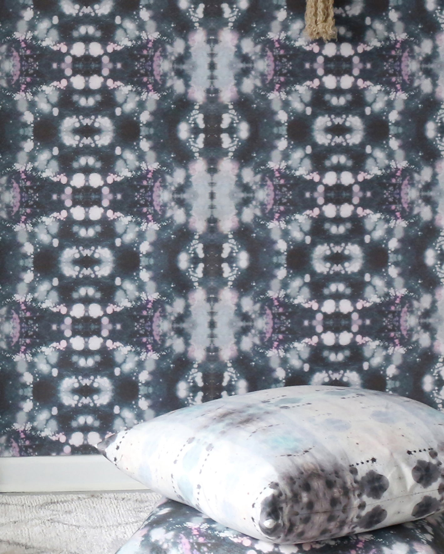 A room with a black and white tie dye wallpaper