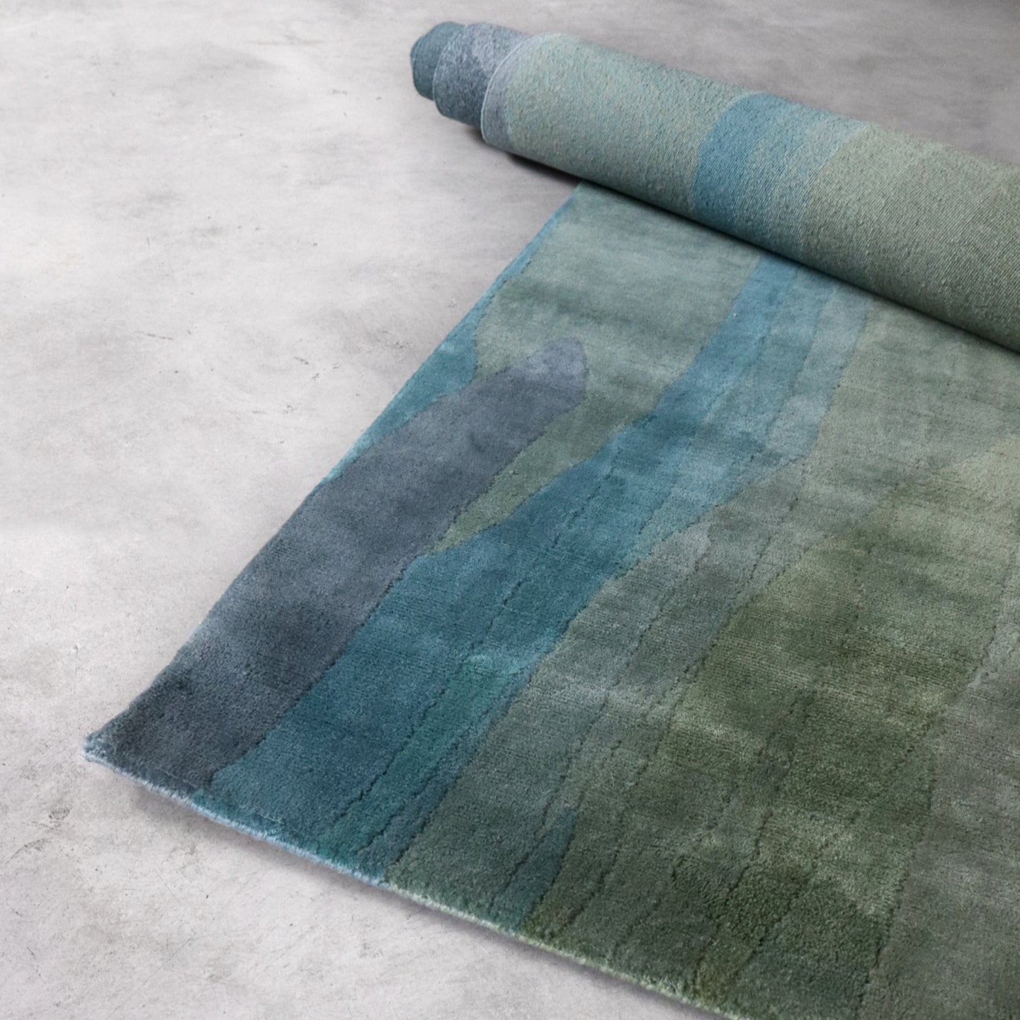 A blue and green rug on a floor
