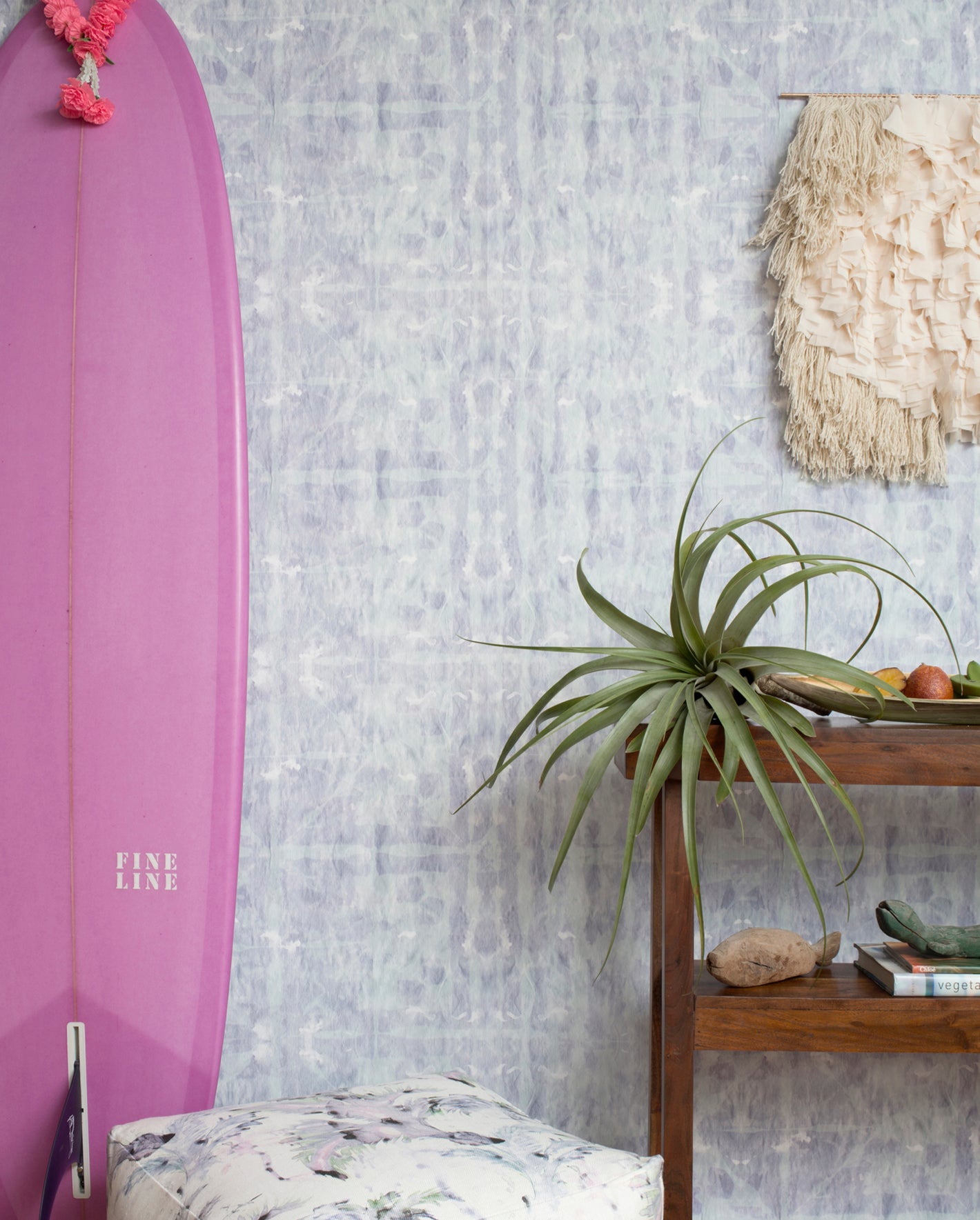 A surfboard leaning against a wall