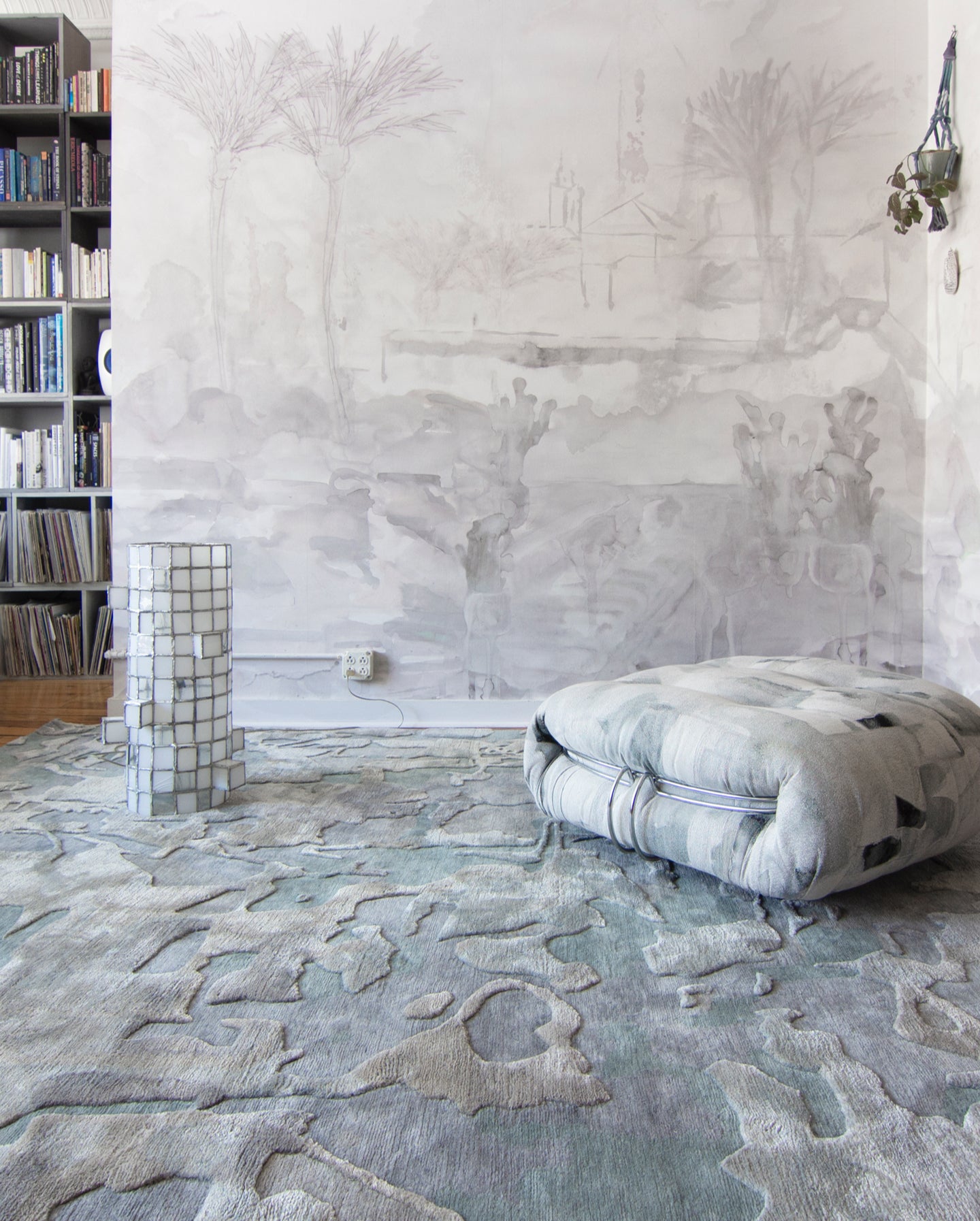 A room with a rug and bookshelves