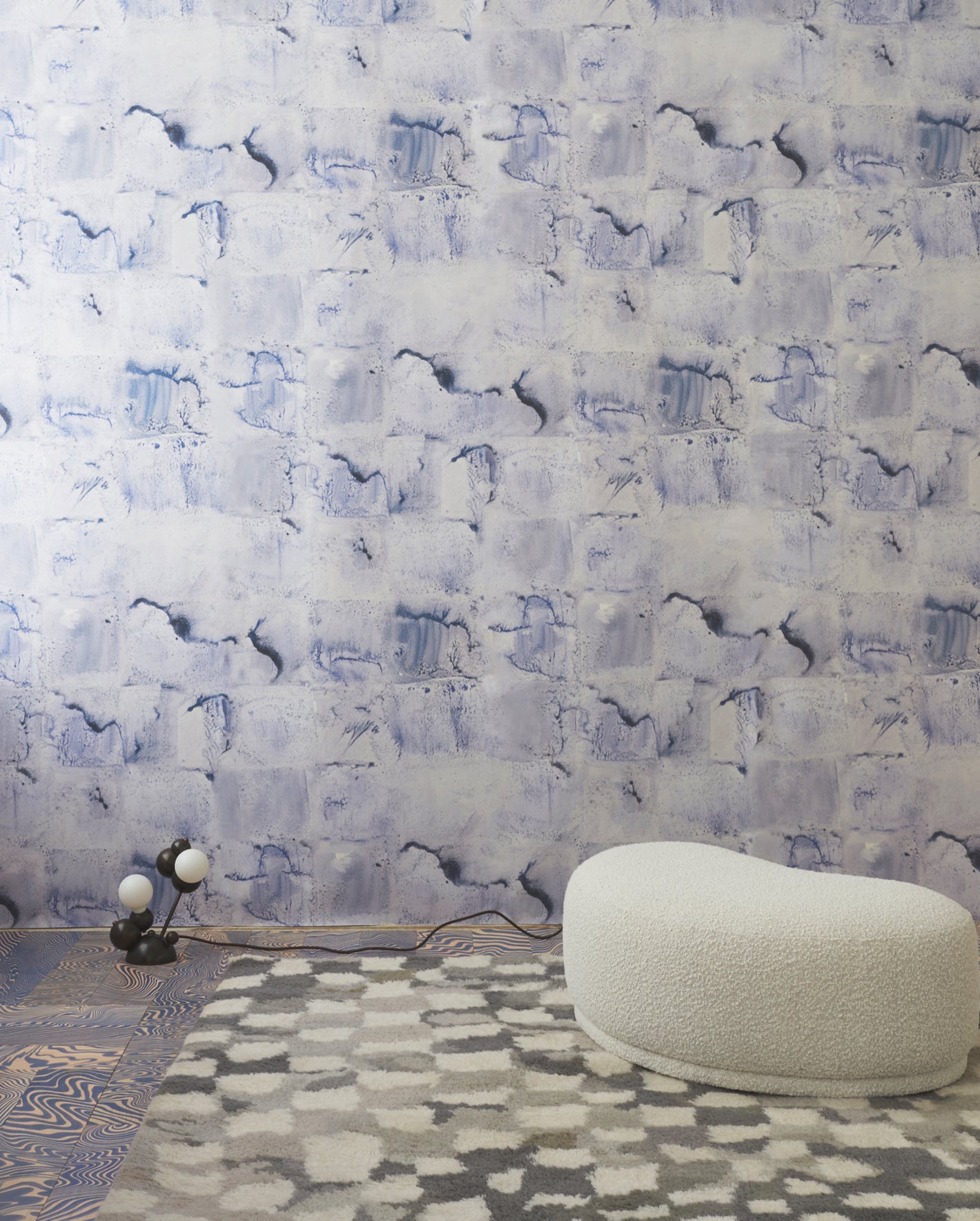 A room with a blue and white wallpaper