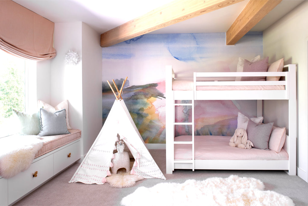 A girl's room with a teepee, bunk beds and a teddy bear