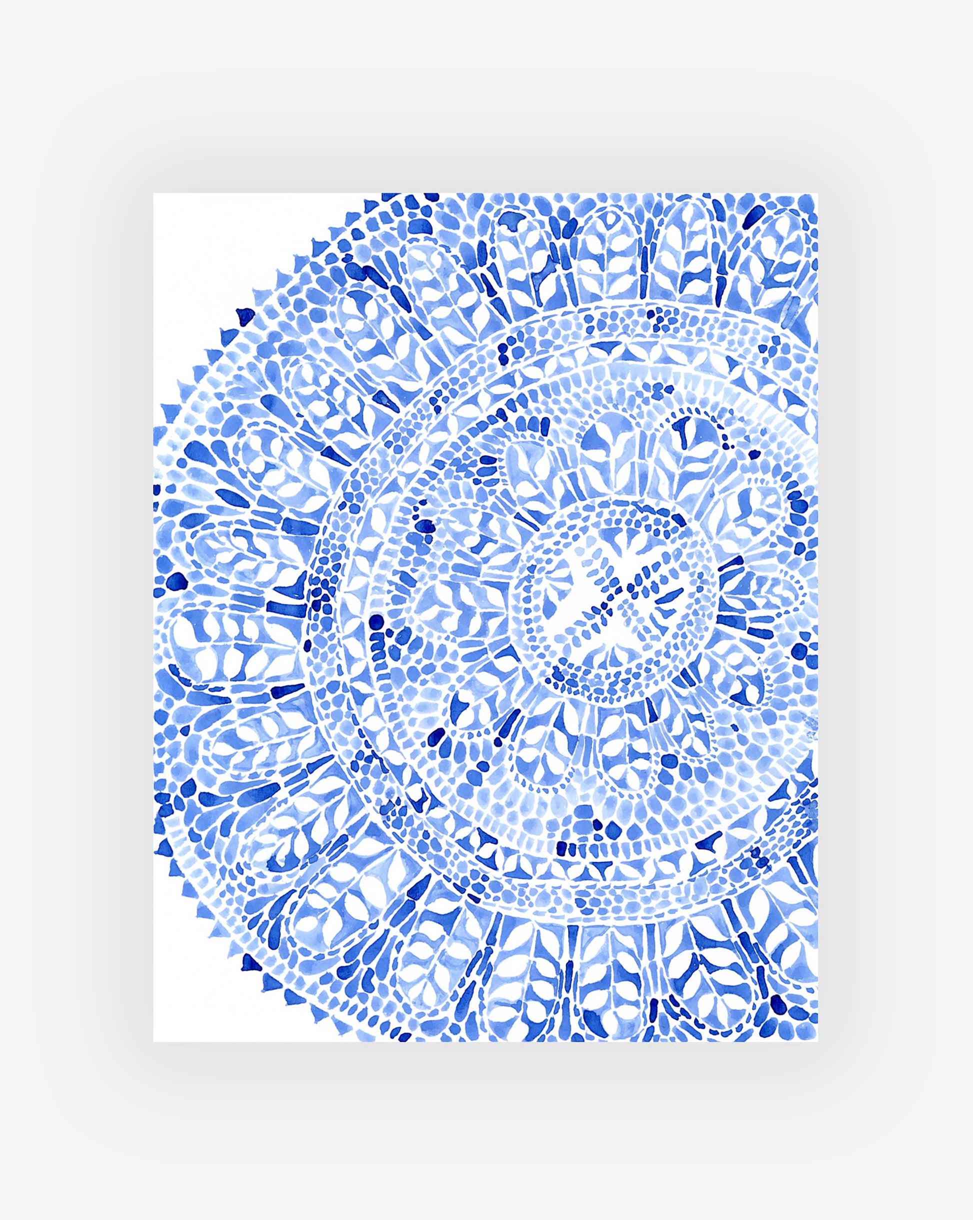 Blue and white circular botanical pattern on a white background